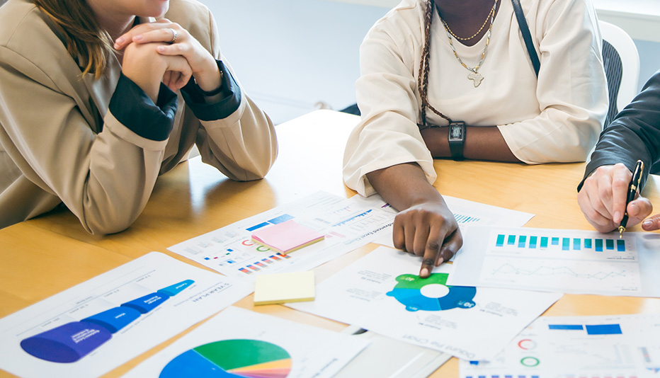 Hiring team reviewing candidate data and hiring metrics during a recruitment strategy session